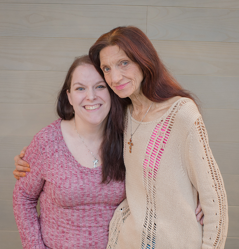 Two medical cannabis patients with one having an arm around the other in support.