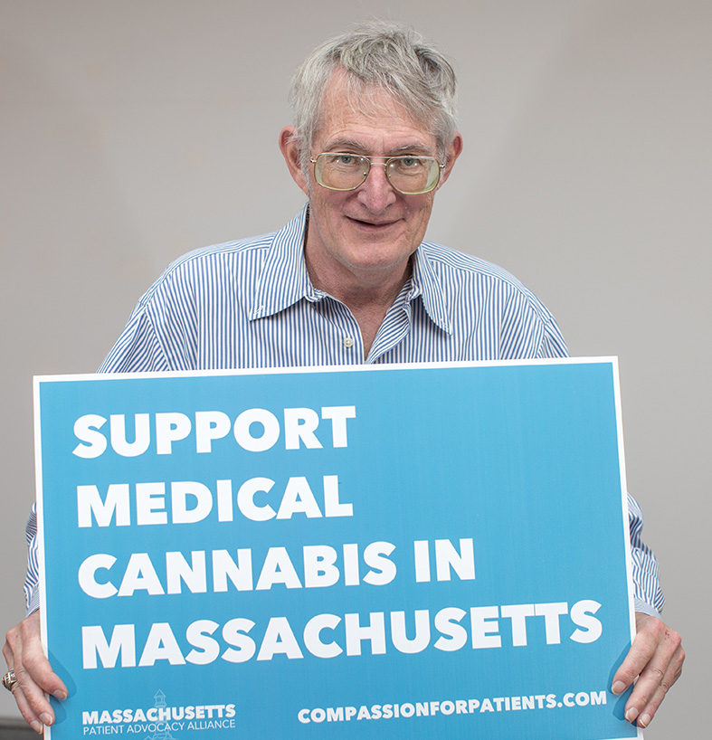 Patient Frank Shaw holding a sign that reads Support Medical Cannabis in Massachusetts